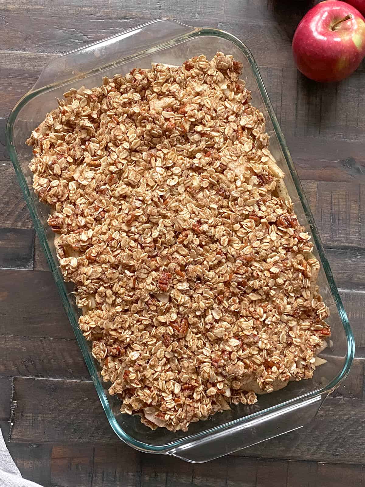 Apple Crisp in a 9x12 baking dish on dark wood table.