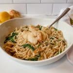 dairy free shrimp scampi pasta dish in a white bowl.