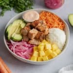 cooked salmon poke bowl assembled in white bowl.