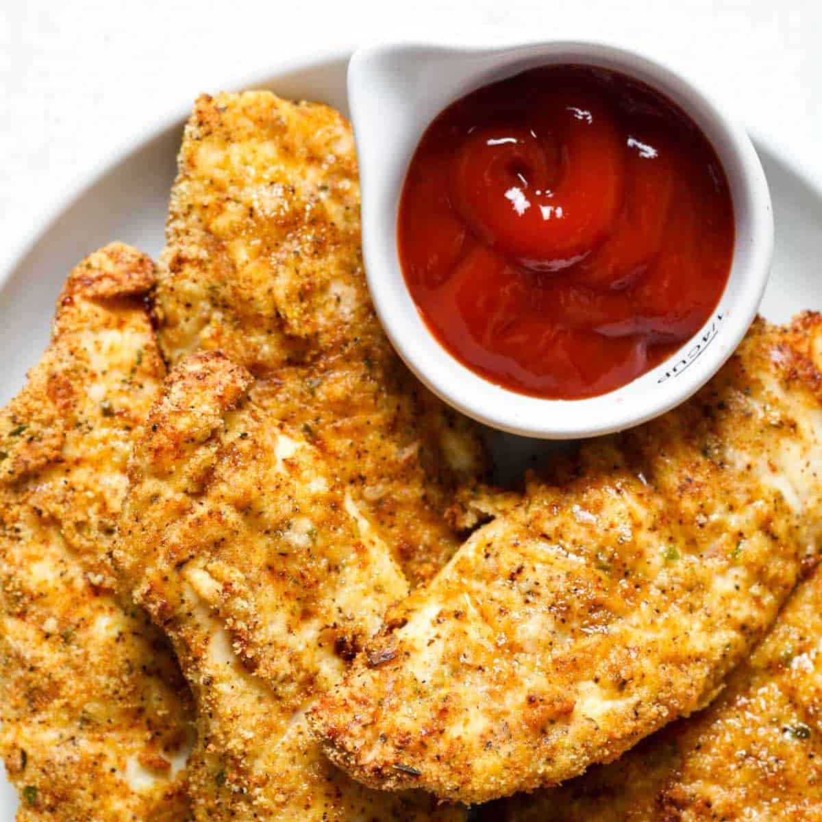 gluten free chicken tenders on platter with ketchup.